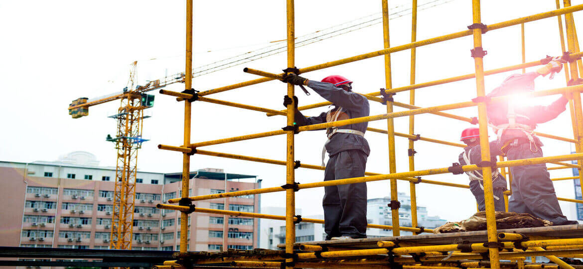 construction workers in city working on scaffolding