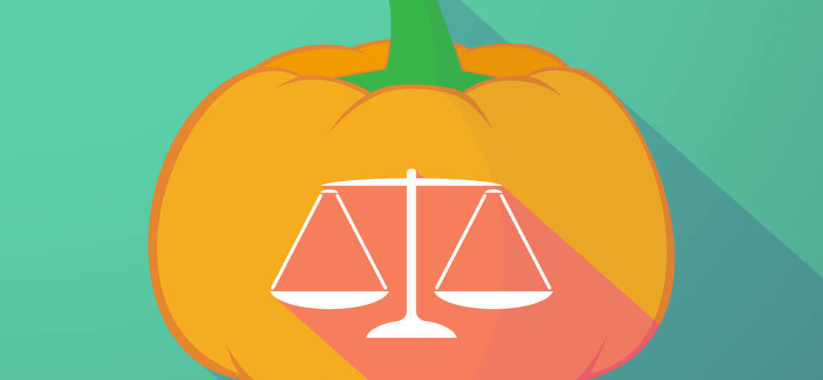 orange pumpkin with scales of justice on pumpkin and background green - Mintz and Geftic Law FIrm Halloween Blog