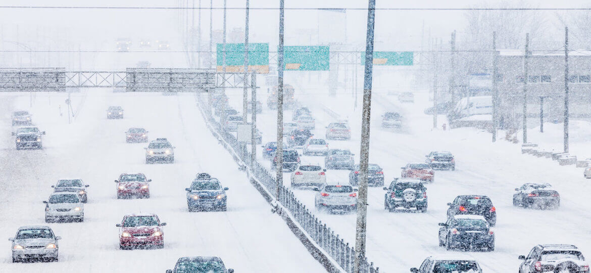 Cars and trucks on snow covered highway during snowstorm - Mintz and Geftic Personal Injury Law Firm